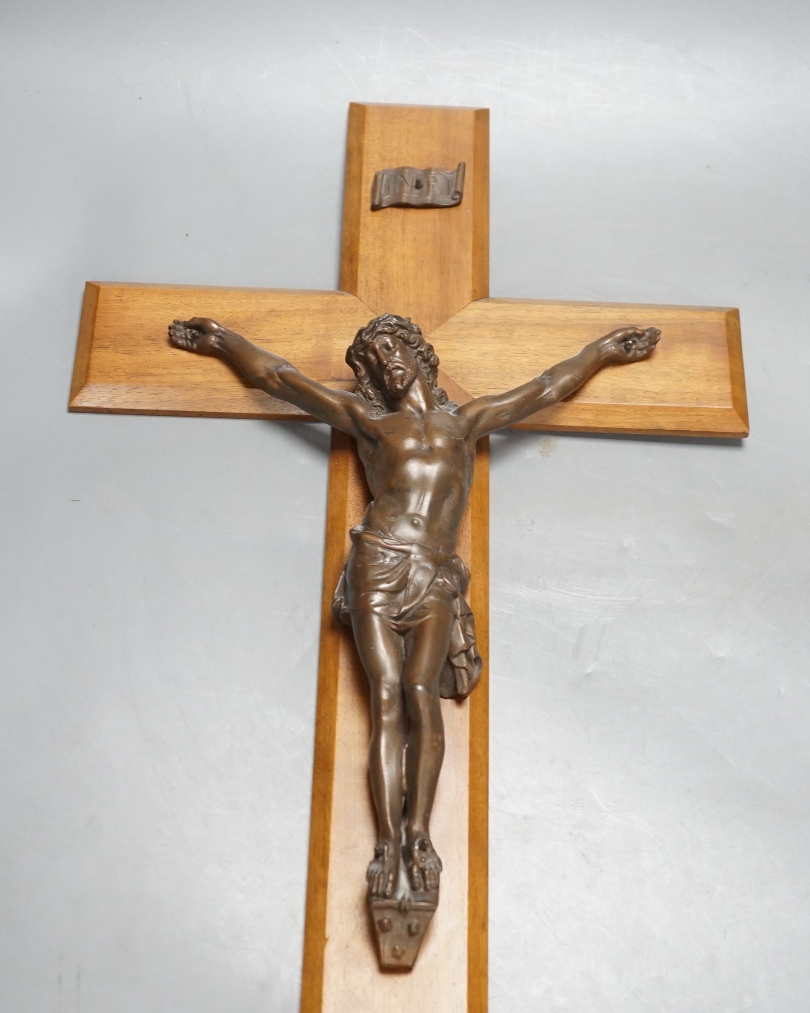 A bronze crucifix, mounted on a wooden cross, Height of cross, 60.5 cms.